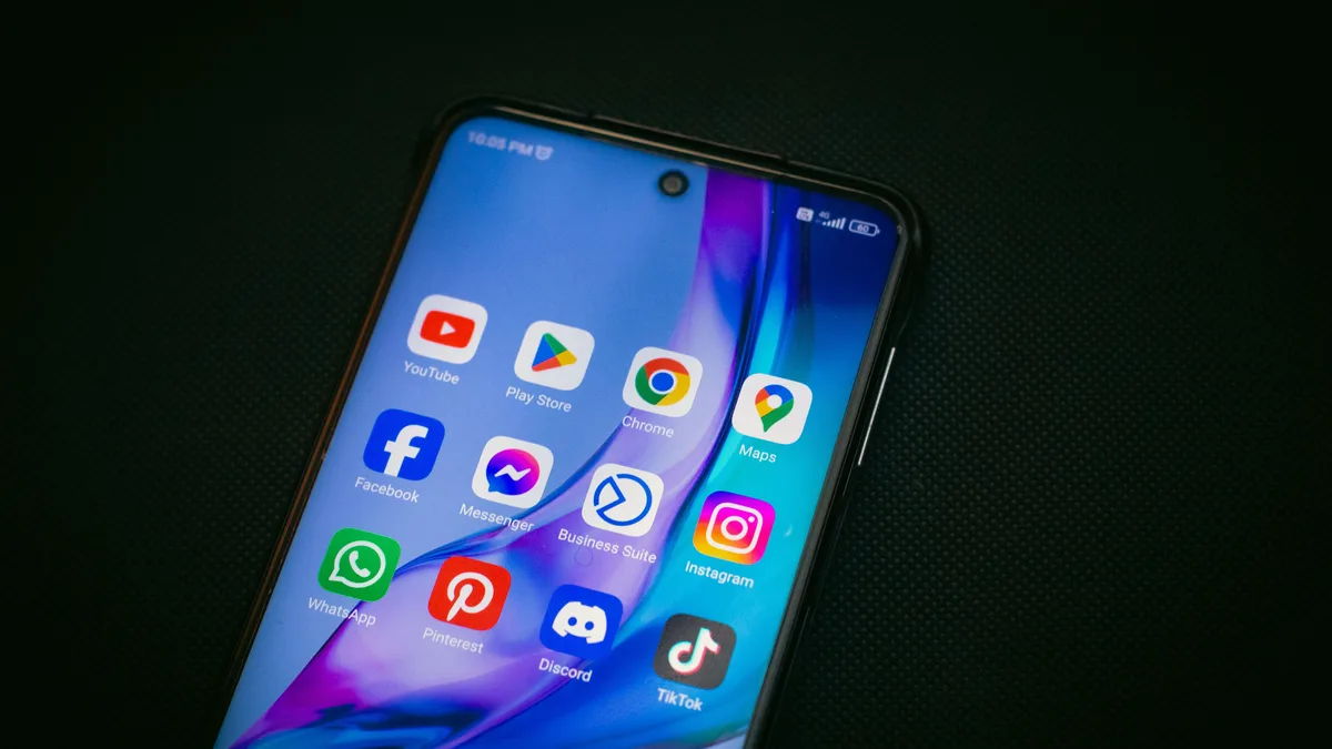Karanlık zeminde sosyal medya uygulamaları bulunan telefon