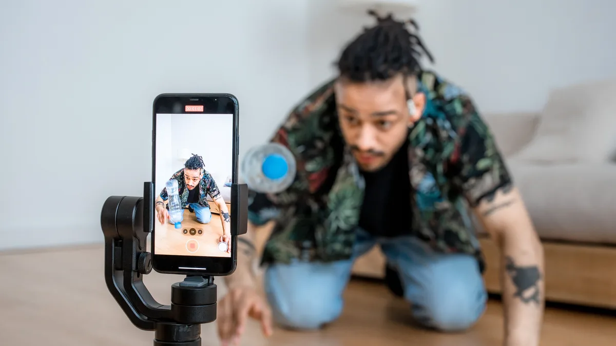 Telefon gimbalıyla evde yaratıcı video çeken kişi