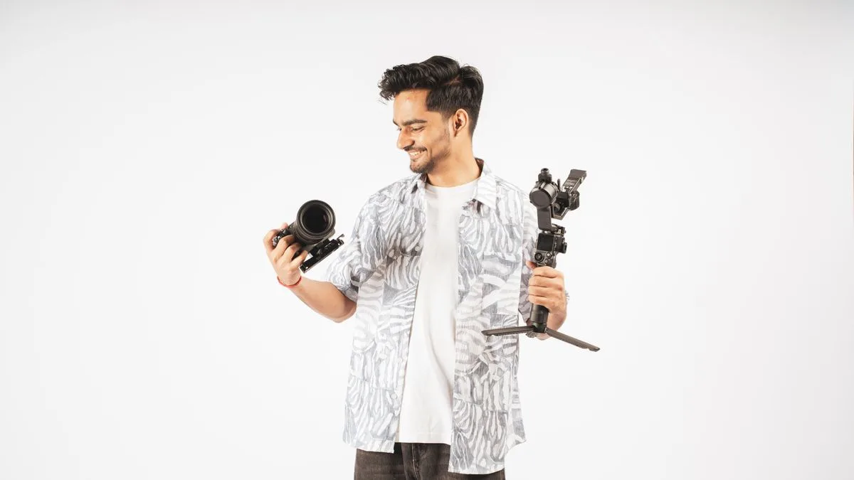 Kamera, gimbal ve lens taşıyan bir videograf
