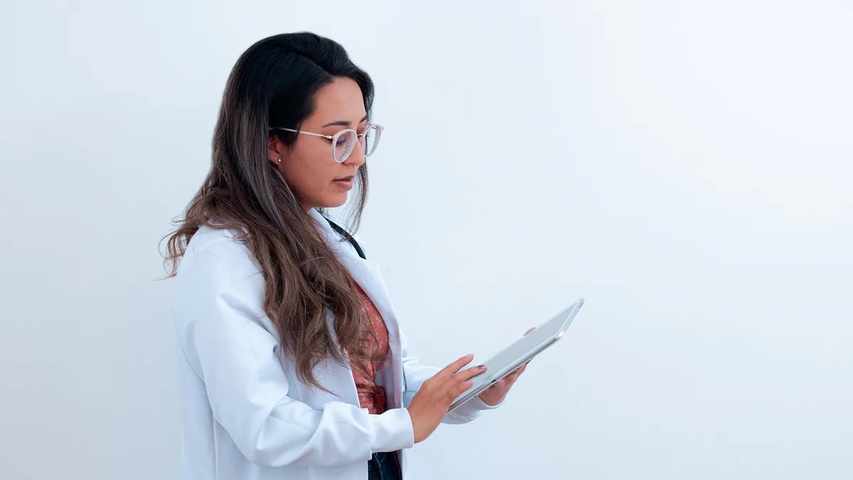 Klinik ortamında notları birlikte inceleyen sağlık çalışanı ve danışan