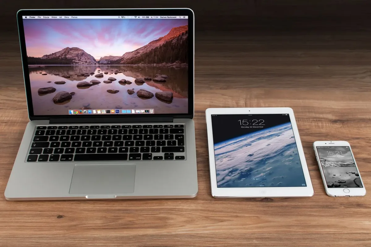 Ahşap masada dizüstü bilgisayar, tablet ve akıllı telefon